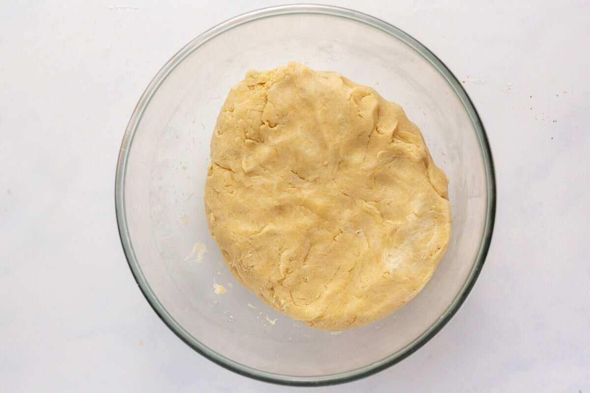 Pie crust dough in glass bowl.