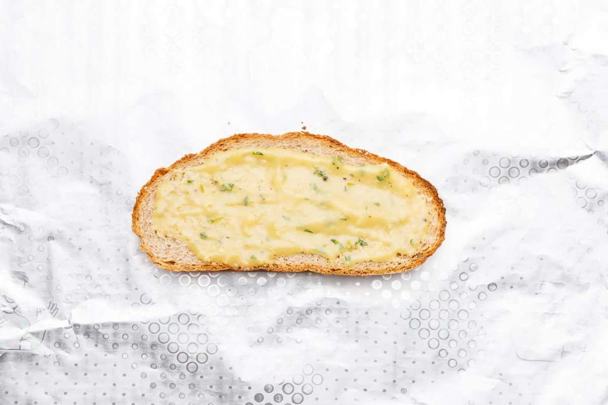 Slice of bread with gravy.