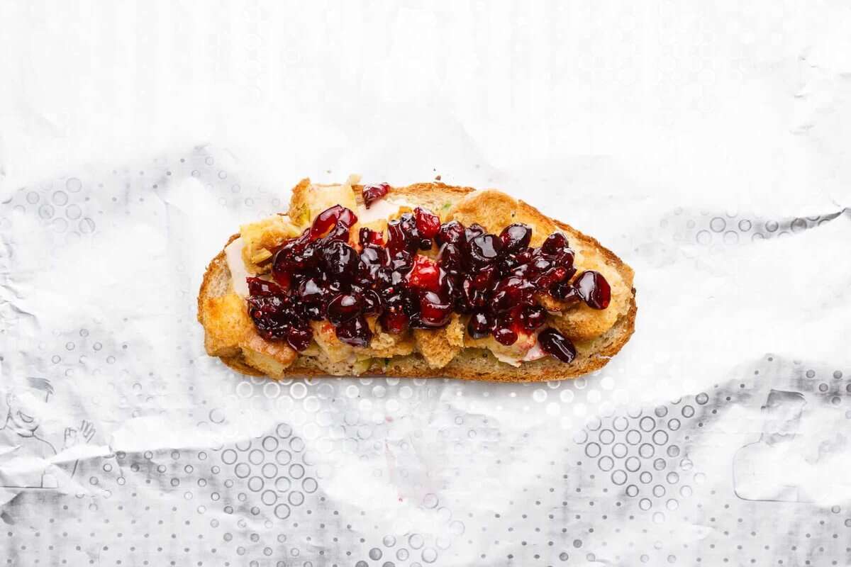 Bread topped with stuffing and cranberry sauce.