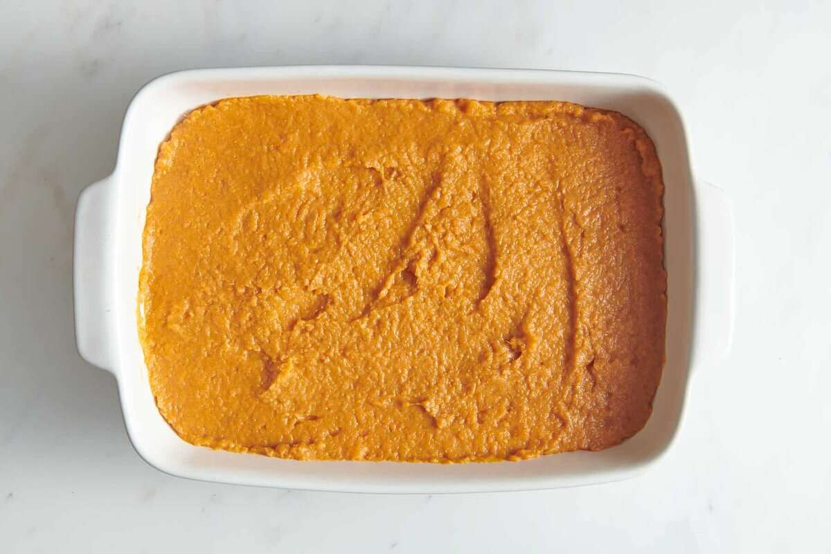 Sweet potato filling spread into baking dish.