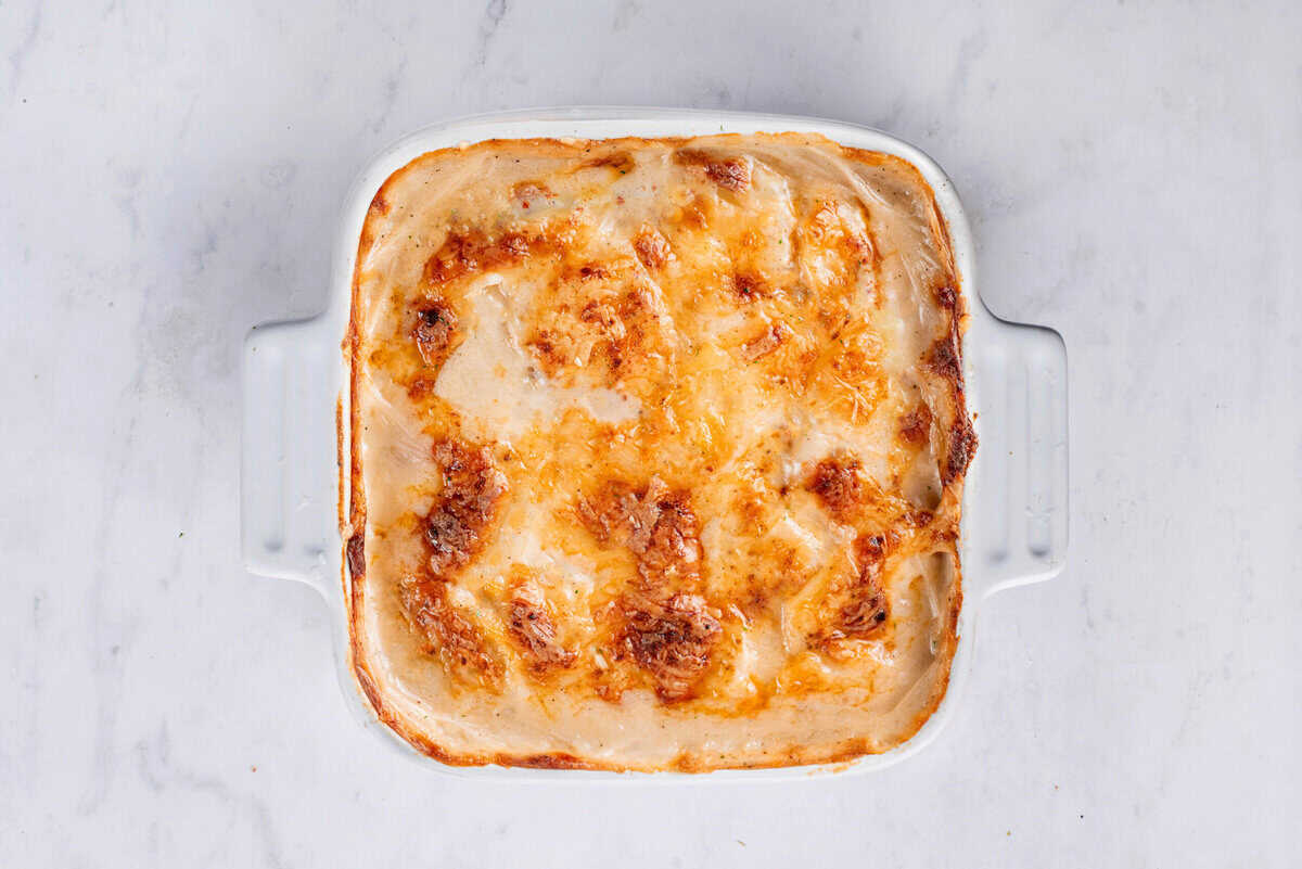 The cheesy au gratin potatoes in the baking dish after baking in the oven.