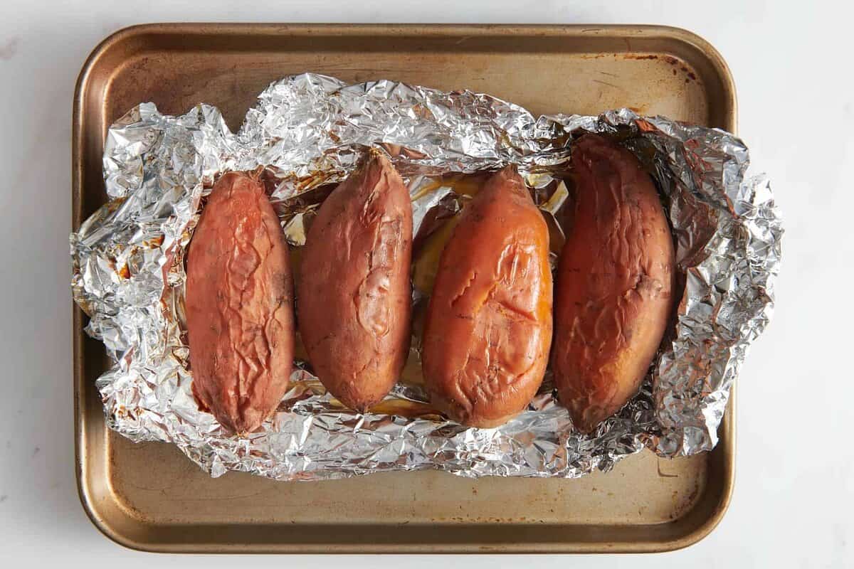 Roasted sweet potatoes on foil lined pan.