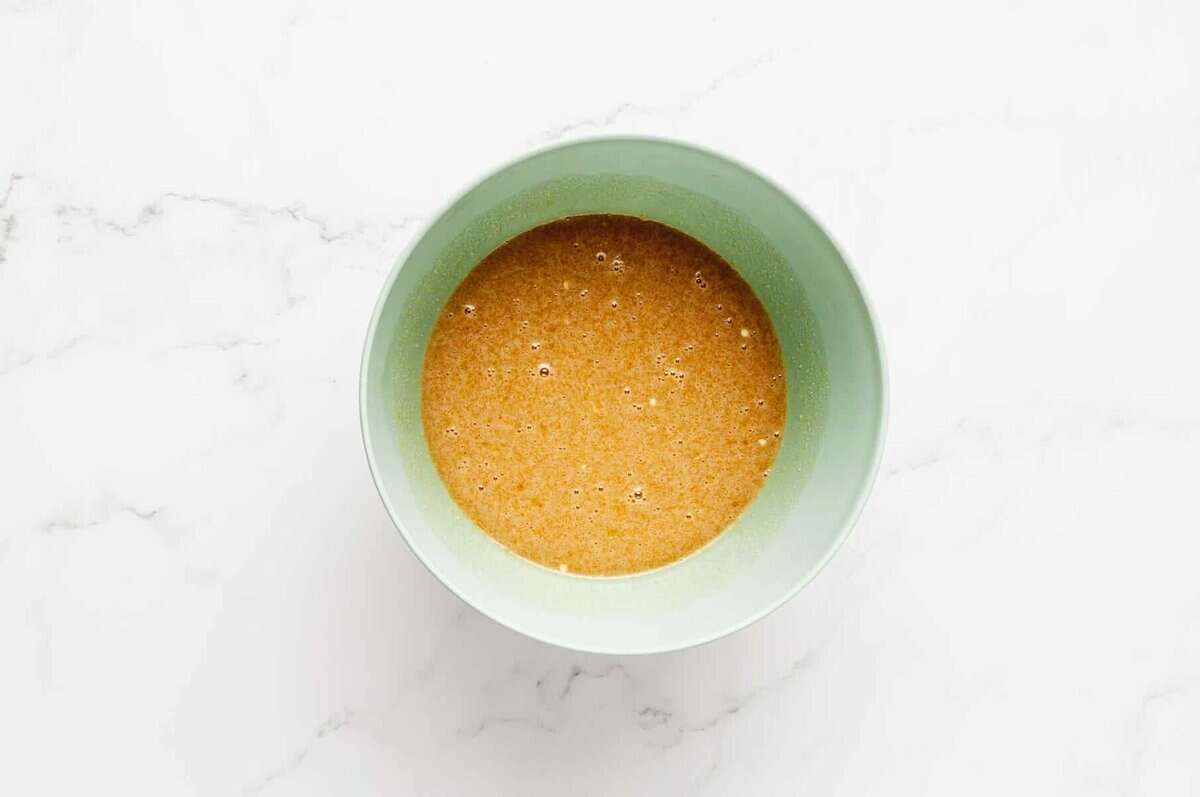 Chocolate pecan pie filling in mixing bowl before adding nuts.