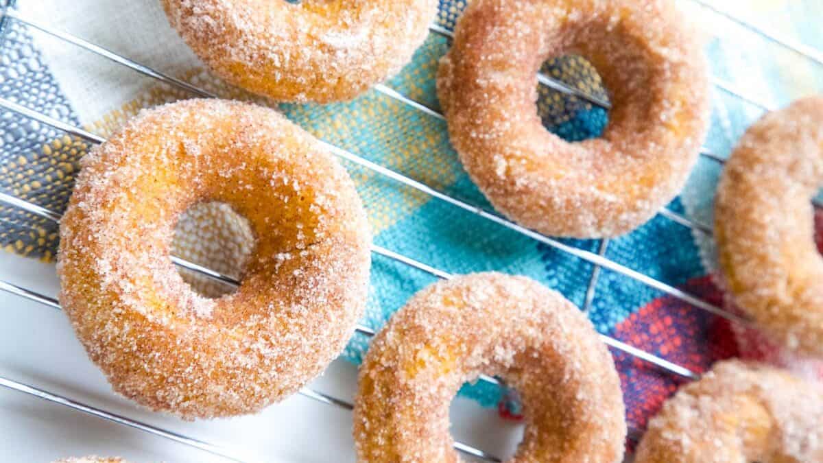 These Baked Pumpkin Spice Donuts, topped with cinnamon-sugar, are the ultimate easy fall dessert! #pumpkin #dessert #donuts #falldessert | allthingsmamma.com