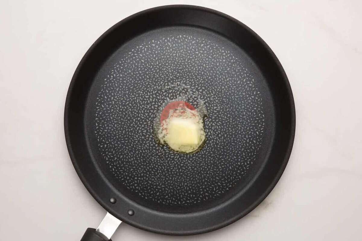 Butter melting in skillet.