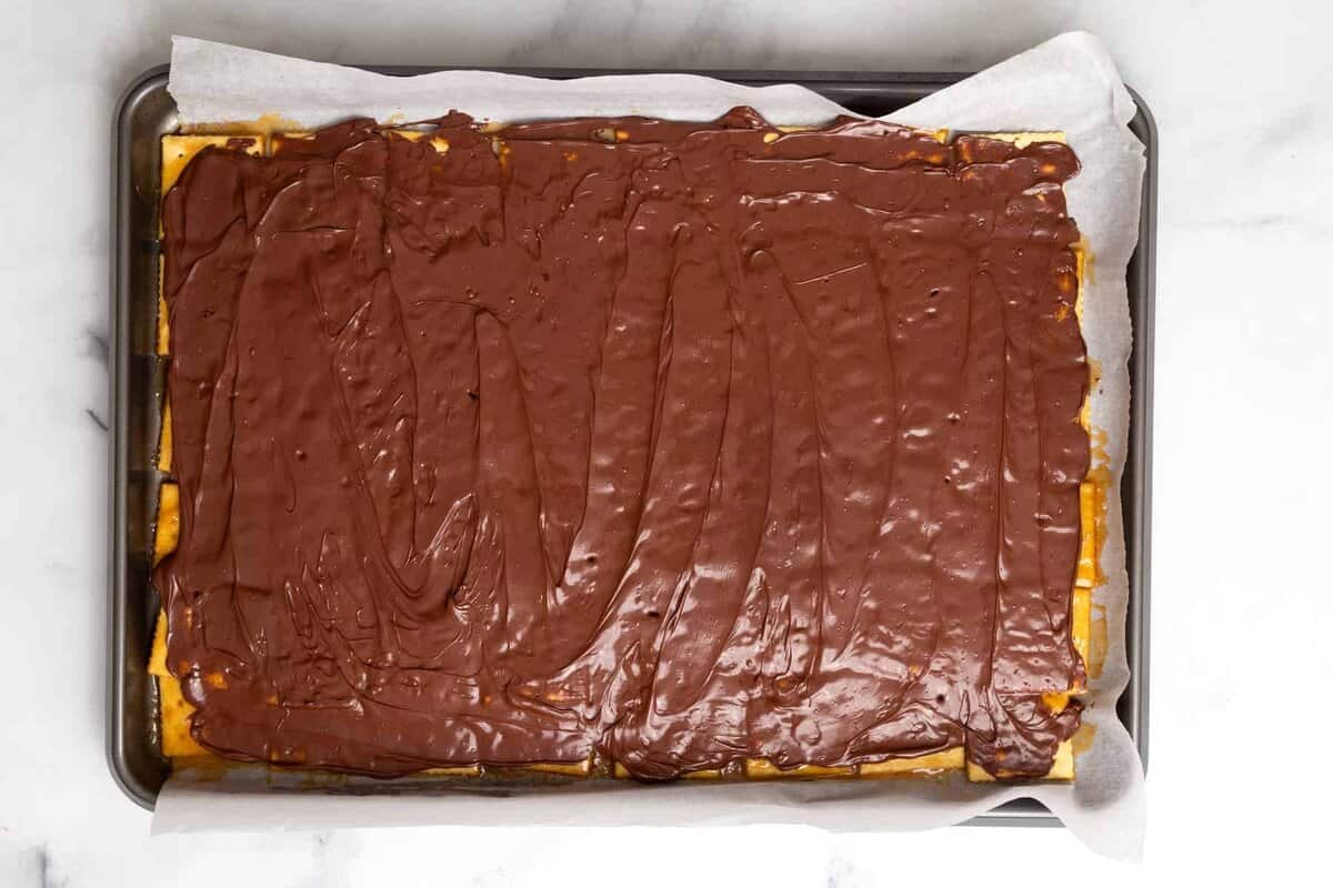 Melted chocolate spread onto Christmas cracker candy.