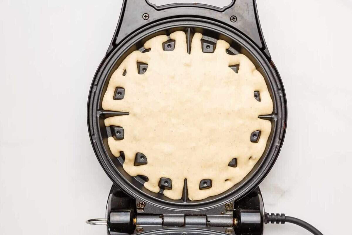Banana waffle batter added to waffle maker.