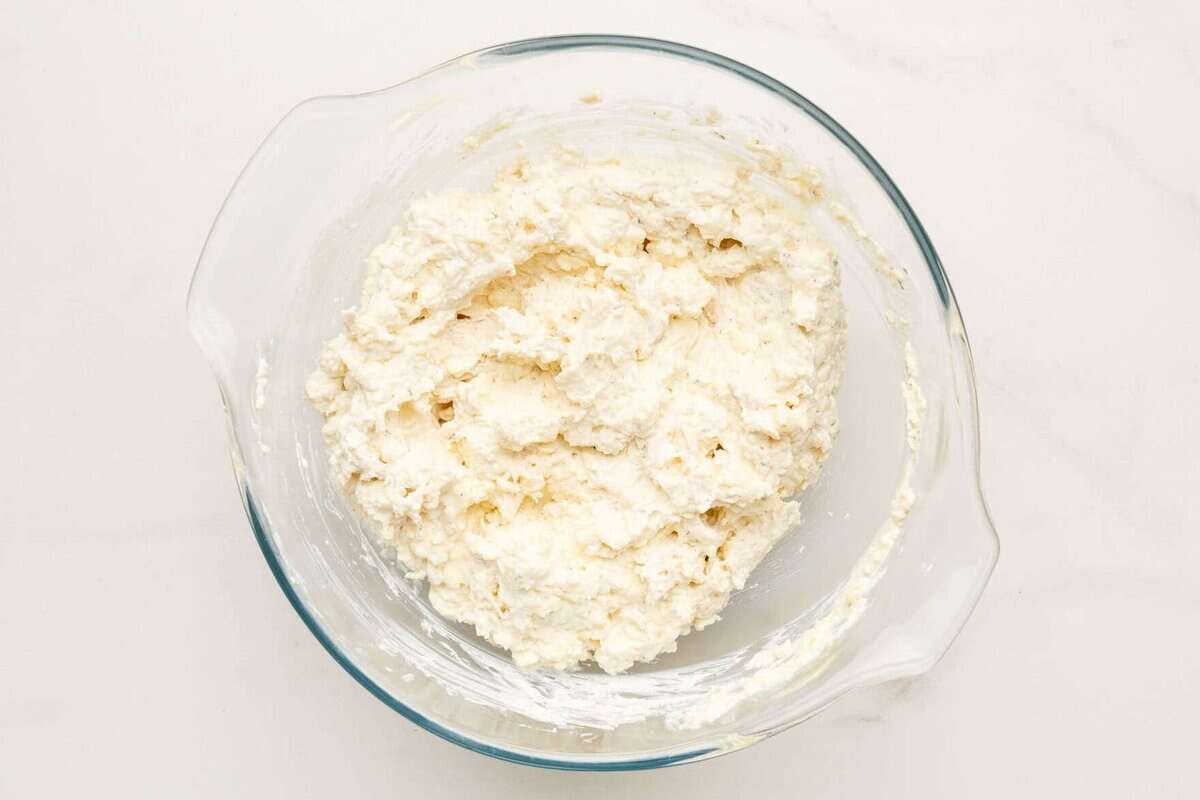Ricotta filling in glass mixing bowl.