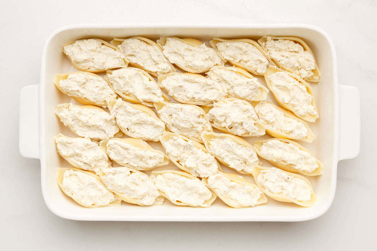 Ricotta stuffed pasta shells in baking dish.