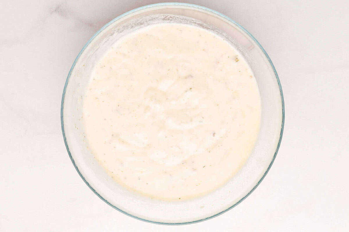 Sauce for pork chops in glass bowl.