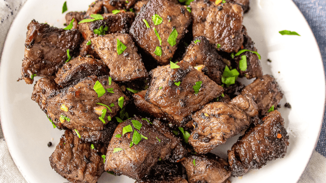 garlic butter steak bites on a white plate