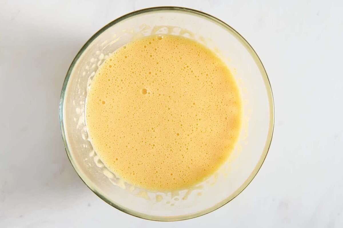 Egg mixture for green chile casserole in bowl.