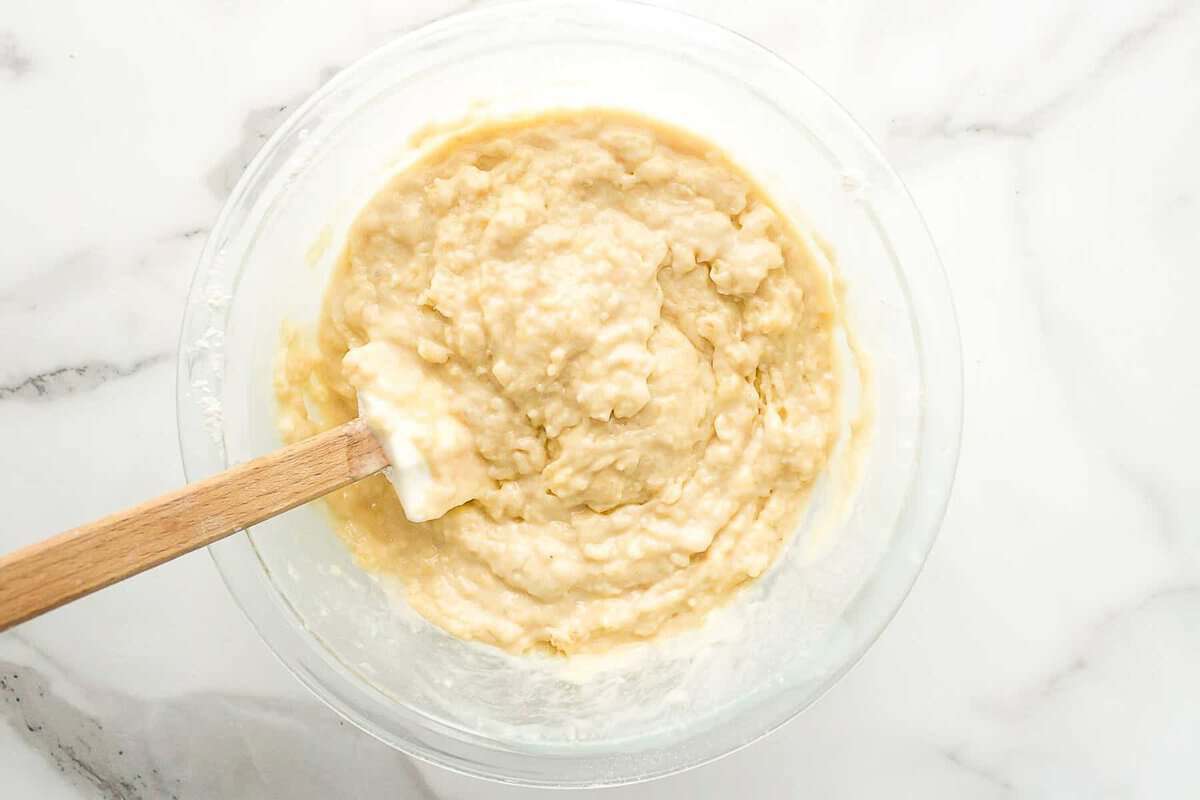 Banana bread muffin batter in mixing bowl.