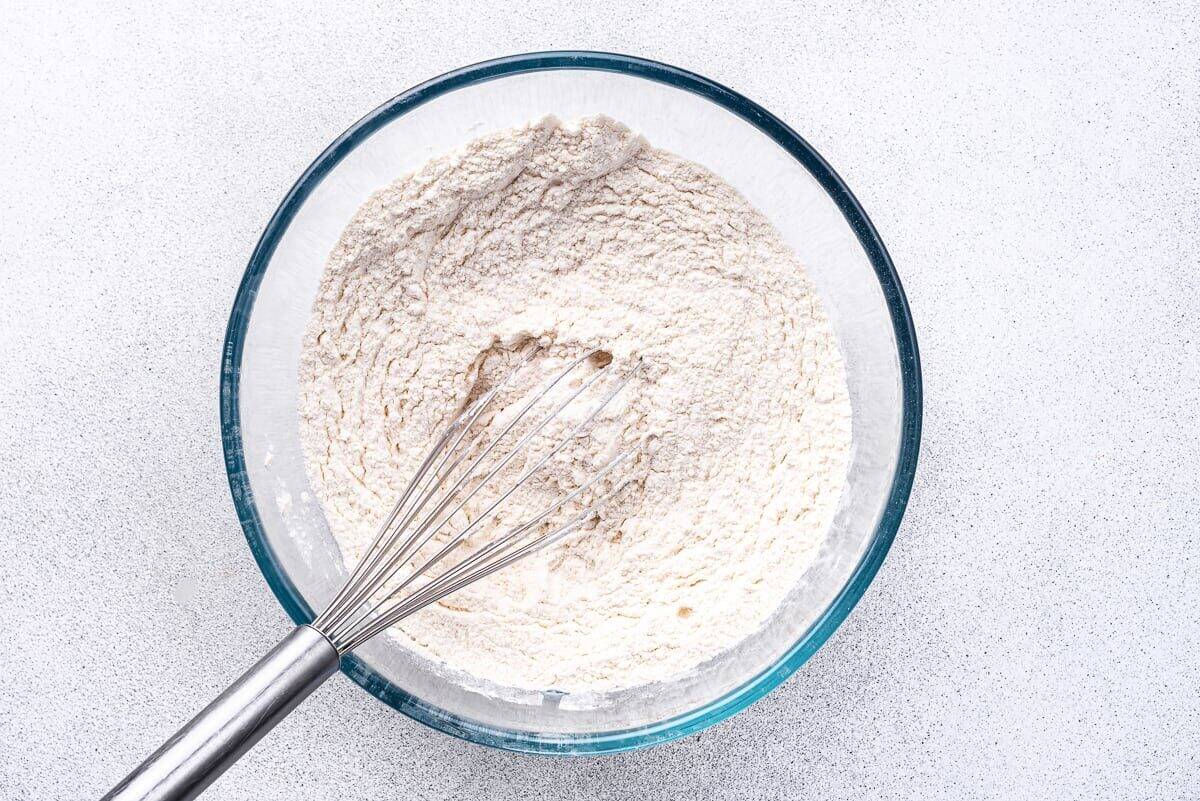 Bowl of dry ingredients with whisk.