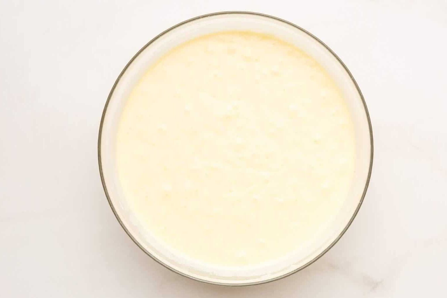 Waffle batter in glass mixing bowl.