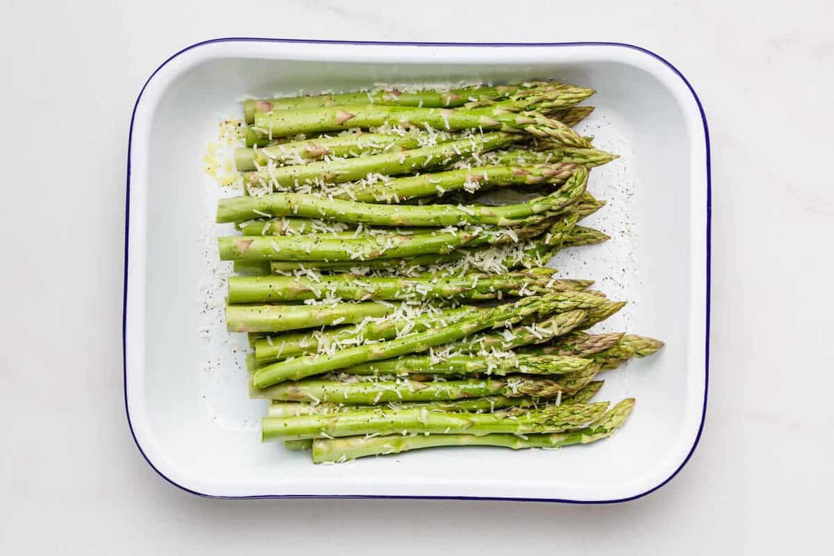 Asparagus and seasonings in pan.