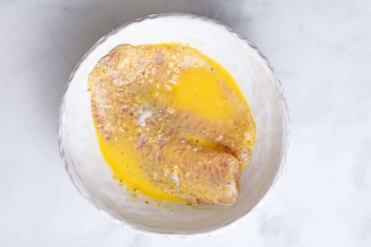 Tilapia in bowl of egg.