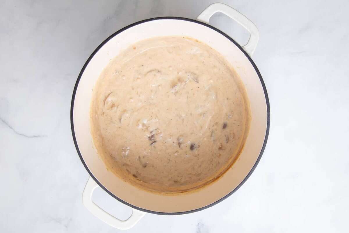 Creamy sauce for ground beef stroganoff in pot.