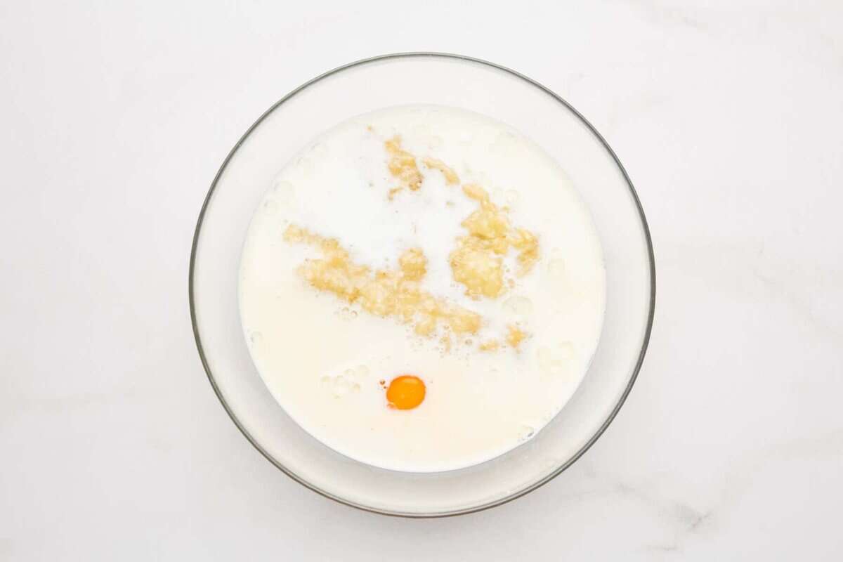 Wet ingredients for banana pancakes in bowl.
