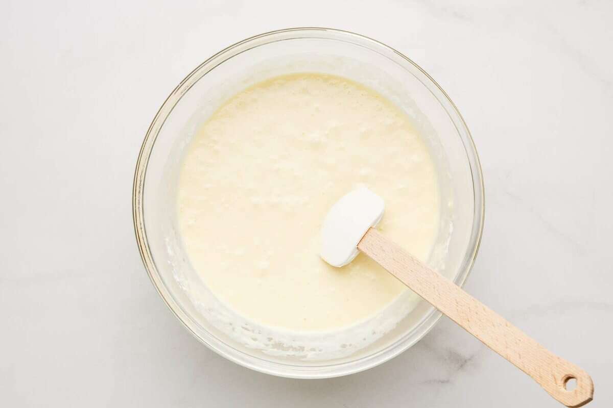 Stirring pancake batter in bowl.