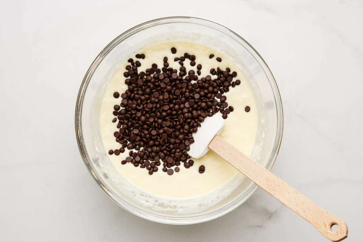 Chocolate chips added to bowl of pancake batter.