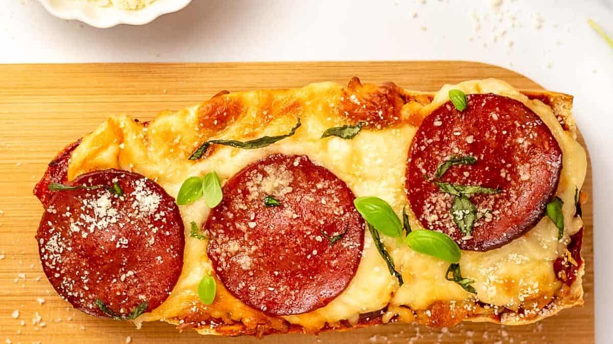 french bread pizza on a wooden platter