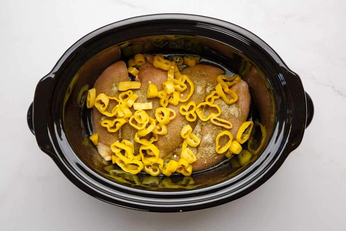 Chicken breasts in slow cooker with banana peppers.