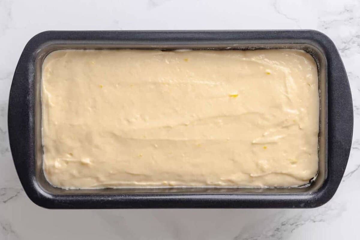 Loaf pan with lemon pound cake batter.