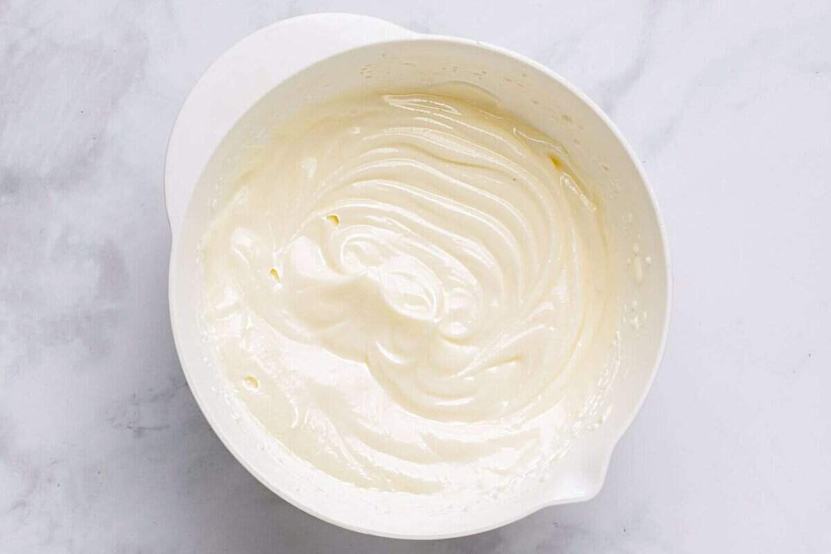 Bowl of light and fluffy cream cheese frosting.