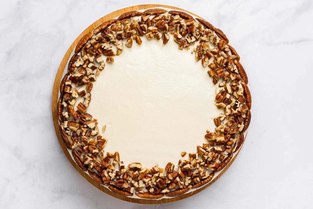 Simple carrot cake with cream cheese frosting and pecans.