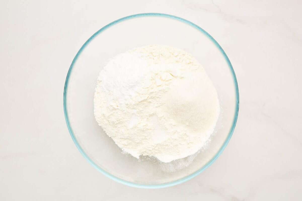 Dry ingredients for pancake batter in glass bowl.