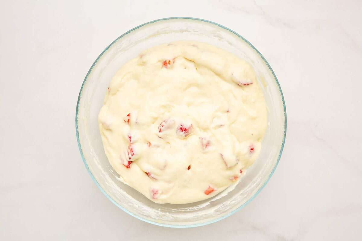 Strawberry pancake batter in glass bowl.