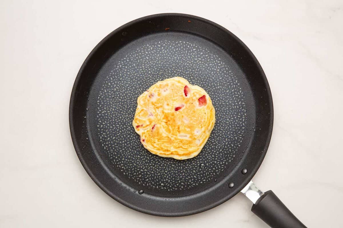 Strawberry pancake in skillet.