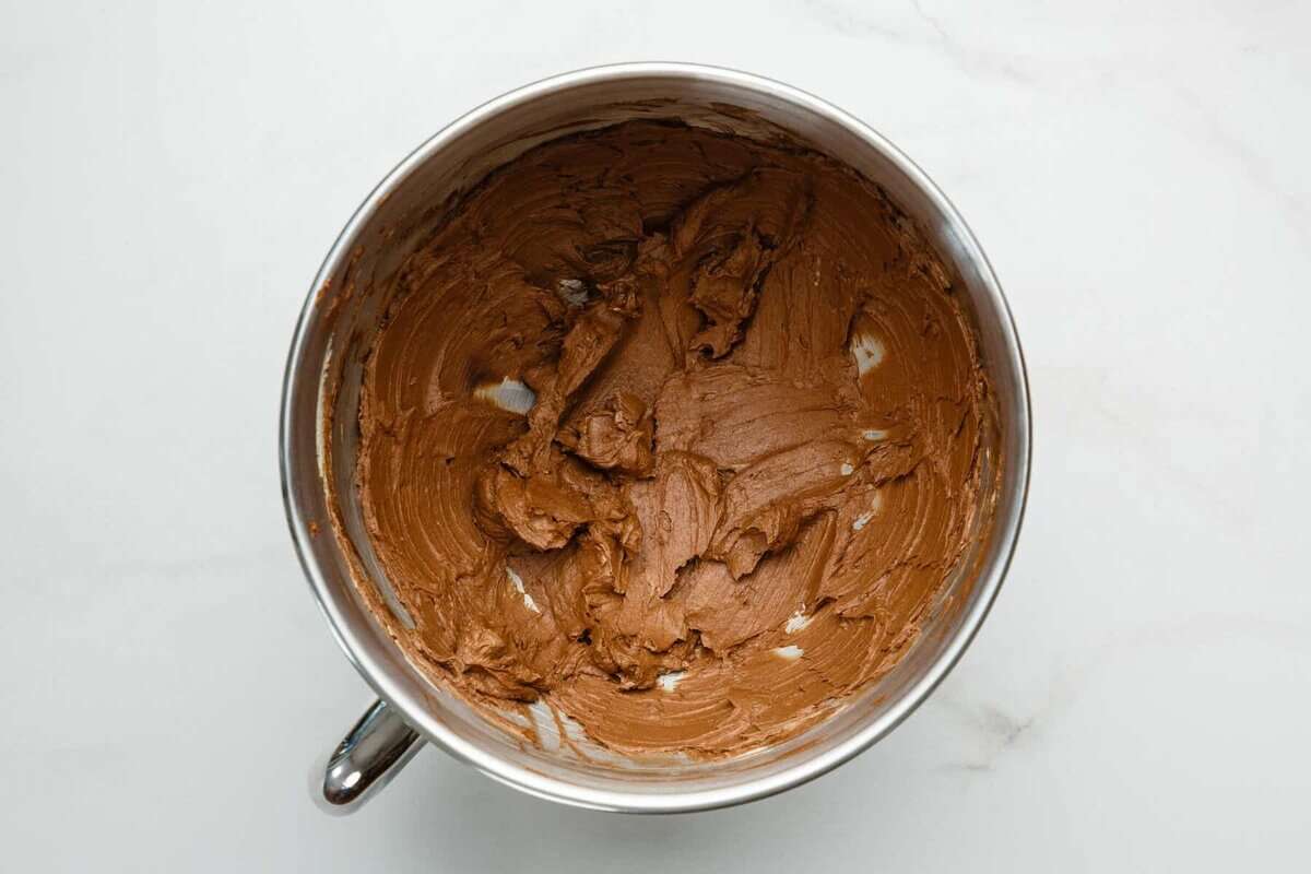 Butter and cocoa powder mixed in bowl.