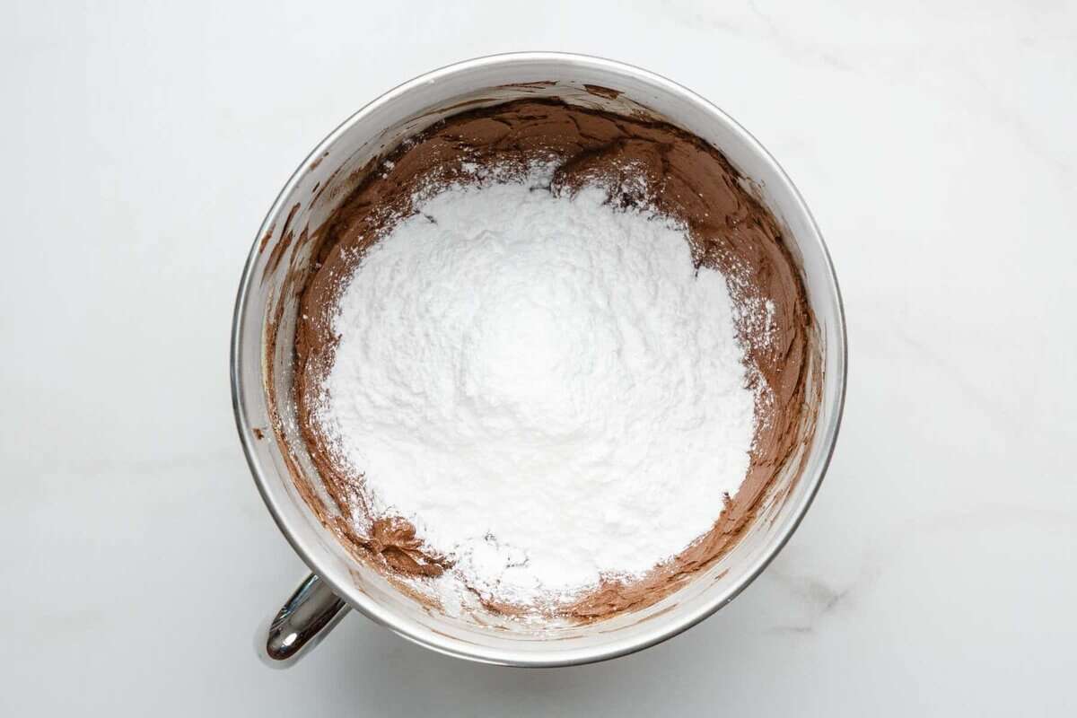 Powdered sugar added to mixing bowl for frosting.