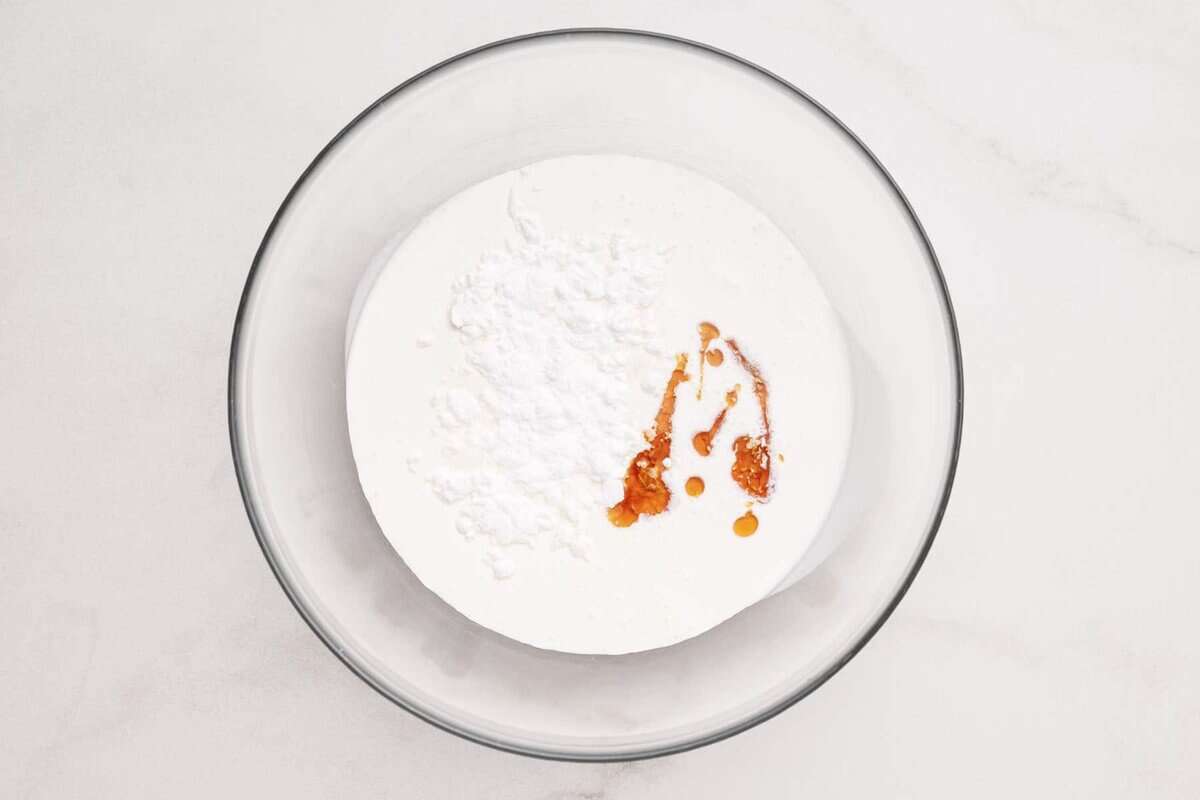 Ingredients for homemade whipped cream in mixing bowl.