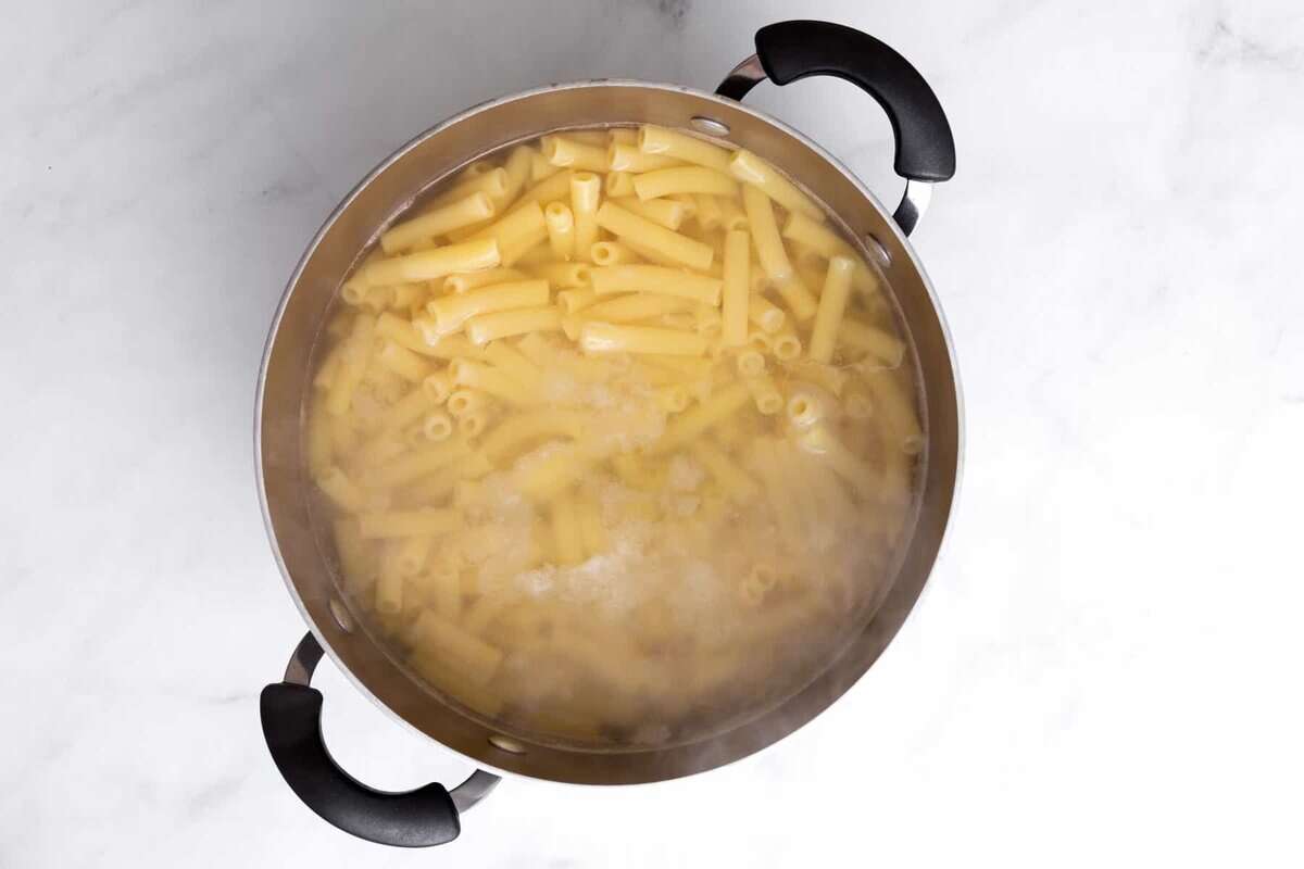 Pasta cooking in pot of water.