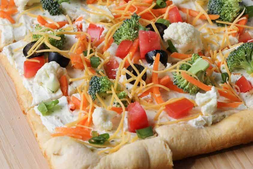 square veggie pizza on a cutting board