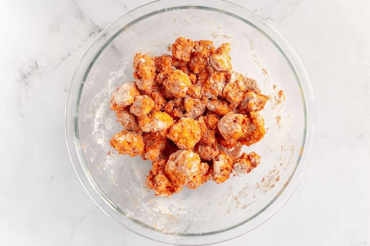 Cauliflower tossed in dry ingredients.