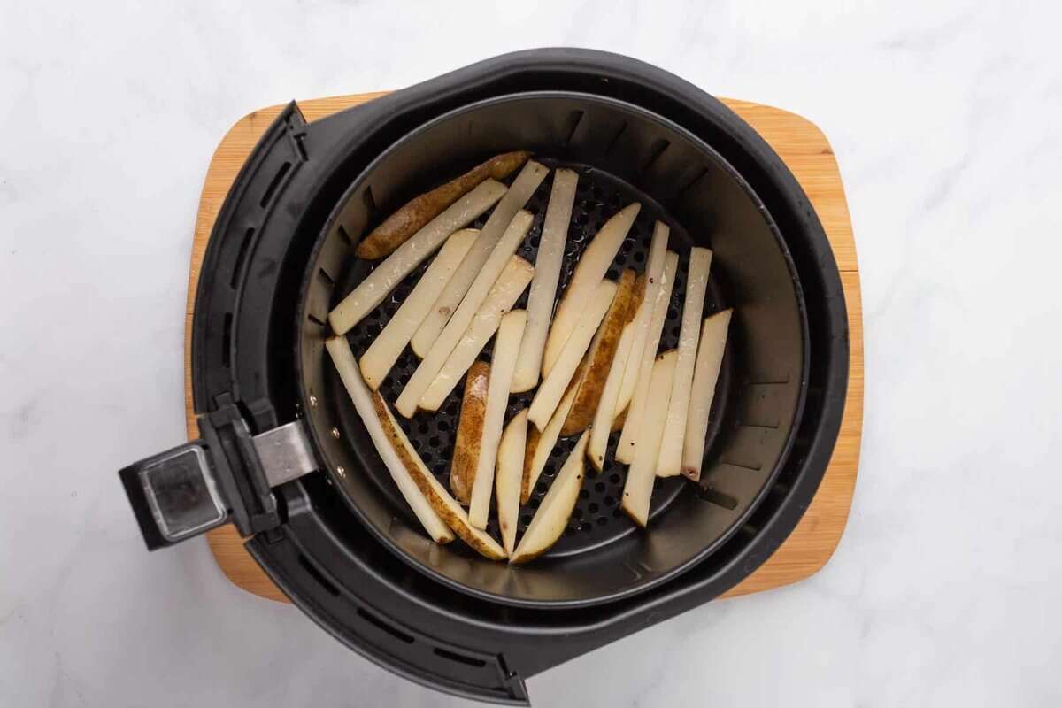 French fries in air fryer basket.