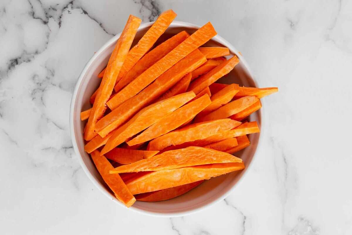 Raw sweet potato fries in bowl.