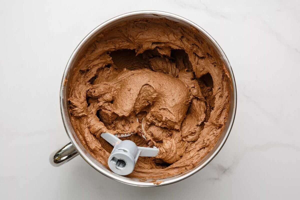 Chocolate frosting in mixing bowl.
