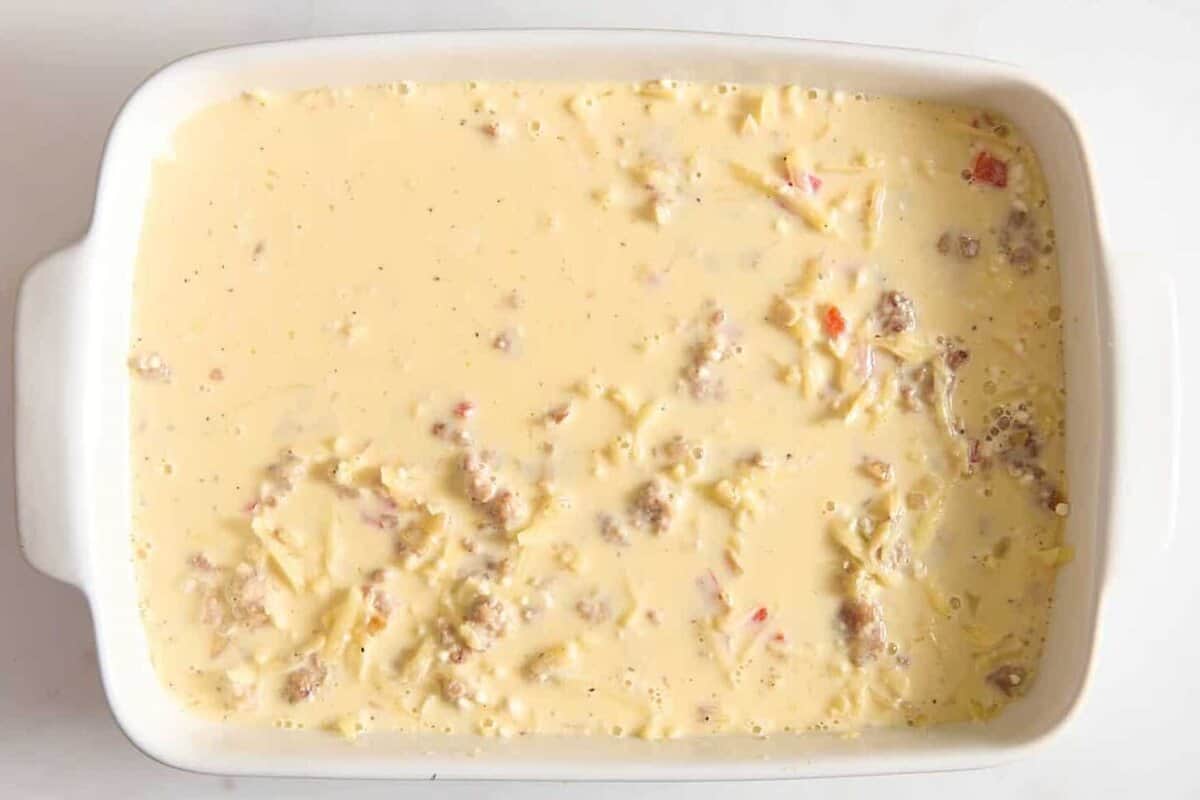 Bisquick mixture poured over breakfast casserole.