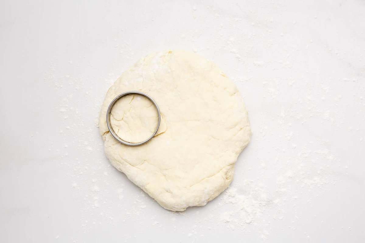 Buttermilk biscuit dough with biscuit cutter.