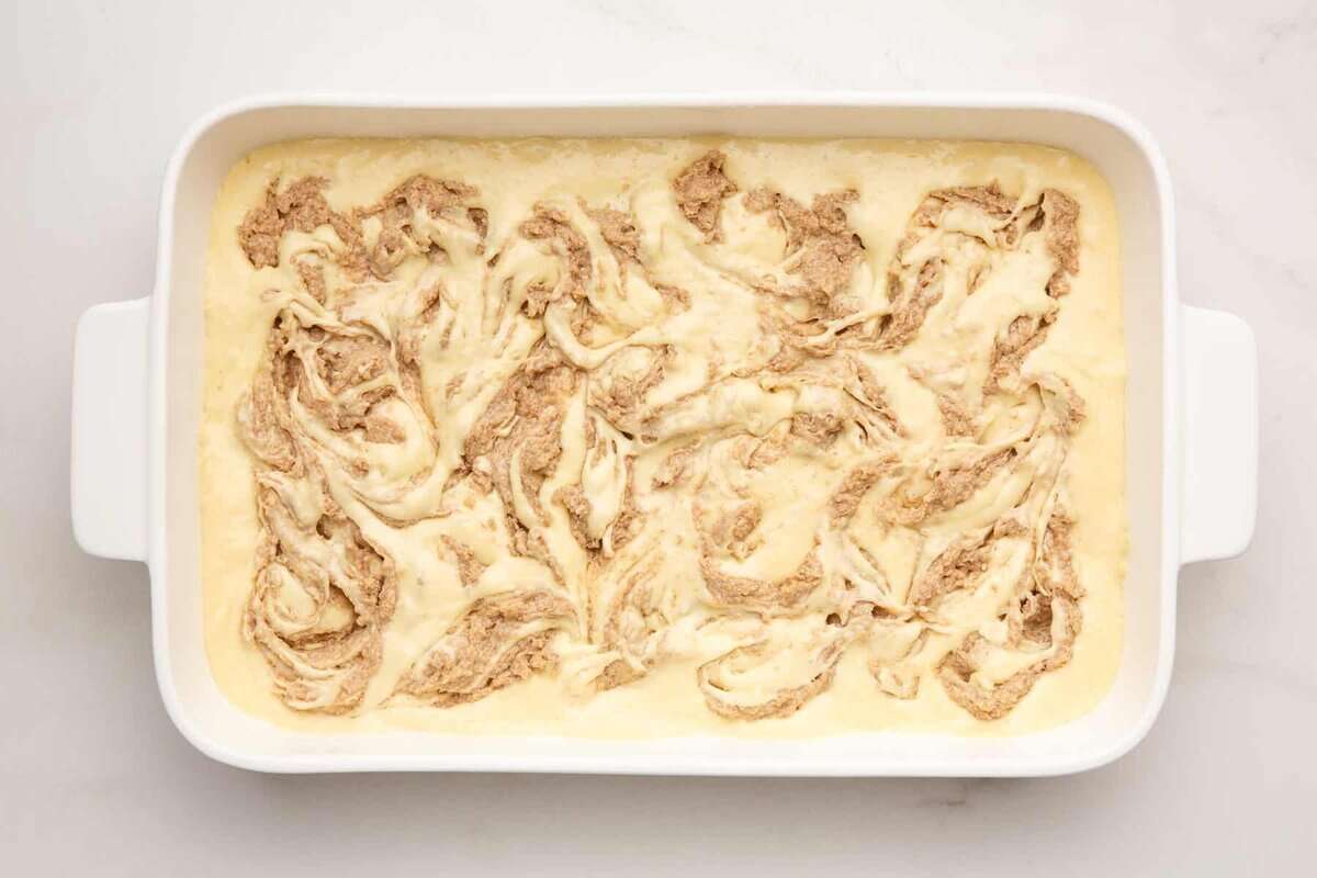 Unbaked cinnamon roll cake in pan.