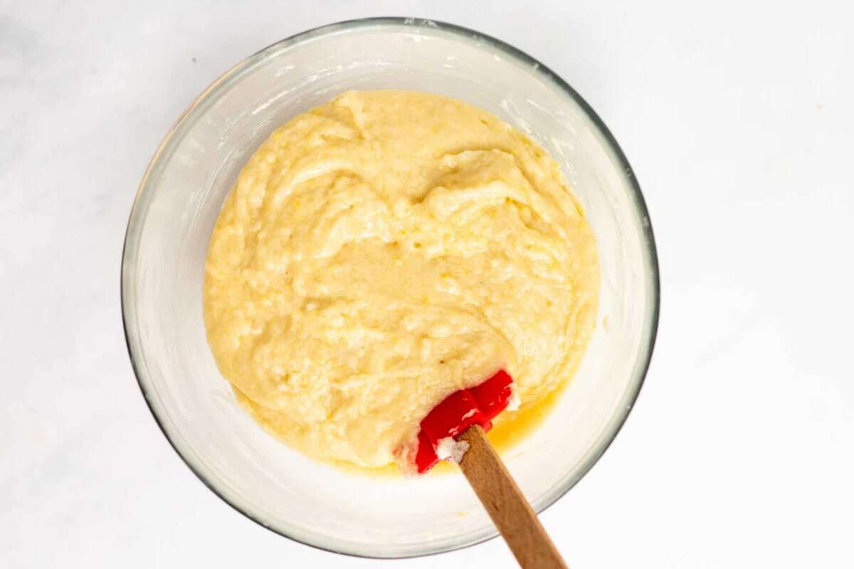 Cinnamon bread batter in bowl with rubber spatula.