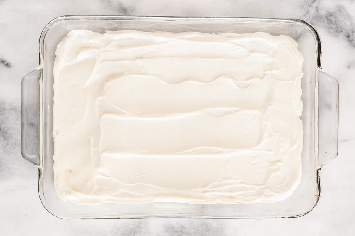Cream cheese layer spread into casserole dish.