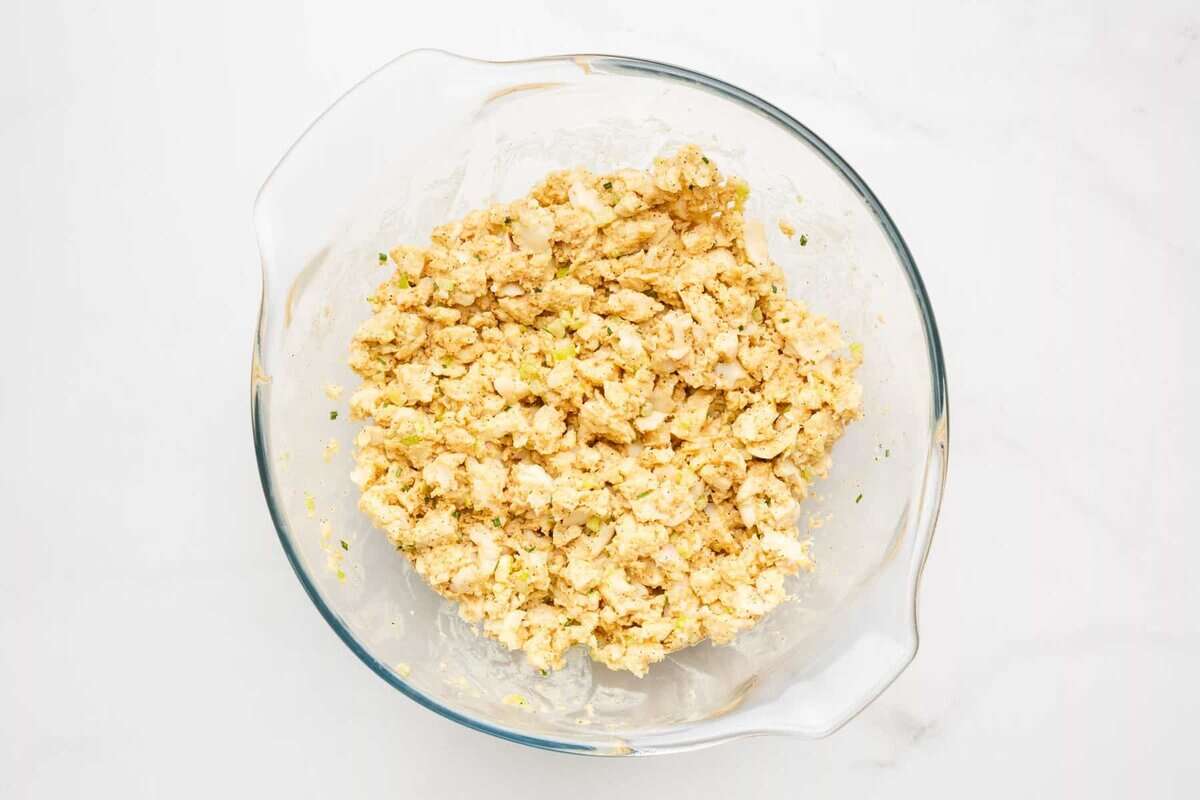 Crab cake mixture in glass bowl.