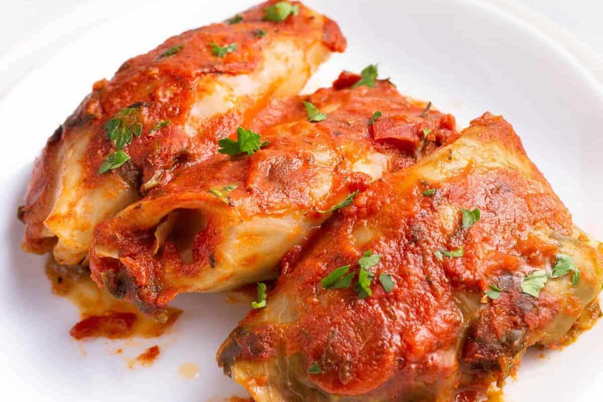 Three slow cooker cabbage rolls on a plate.
