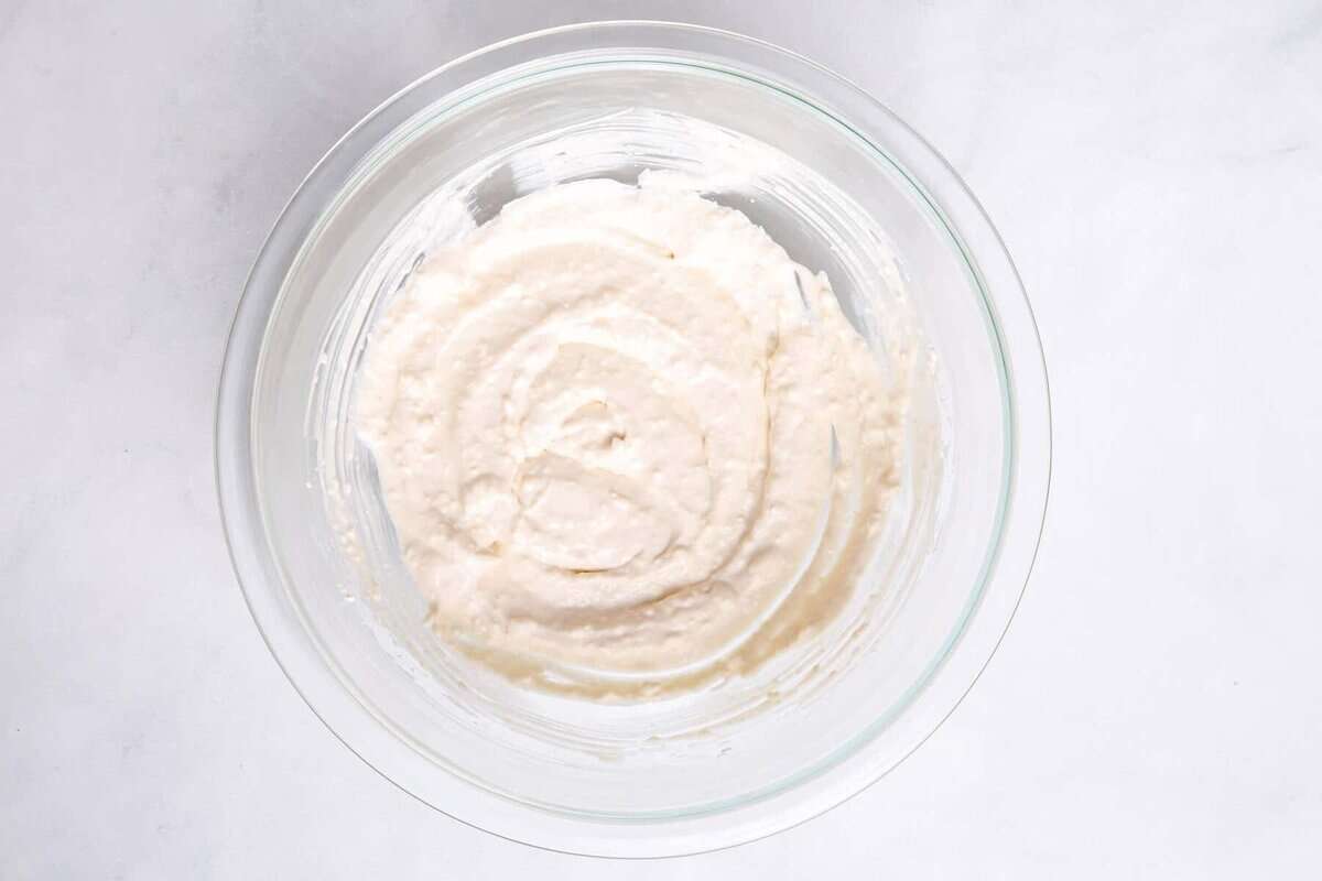 Cream cheese dressing for grape salad in bowl.